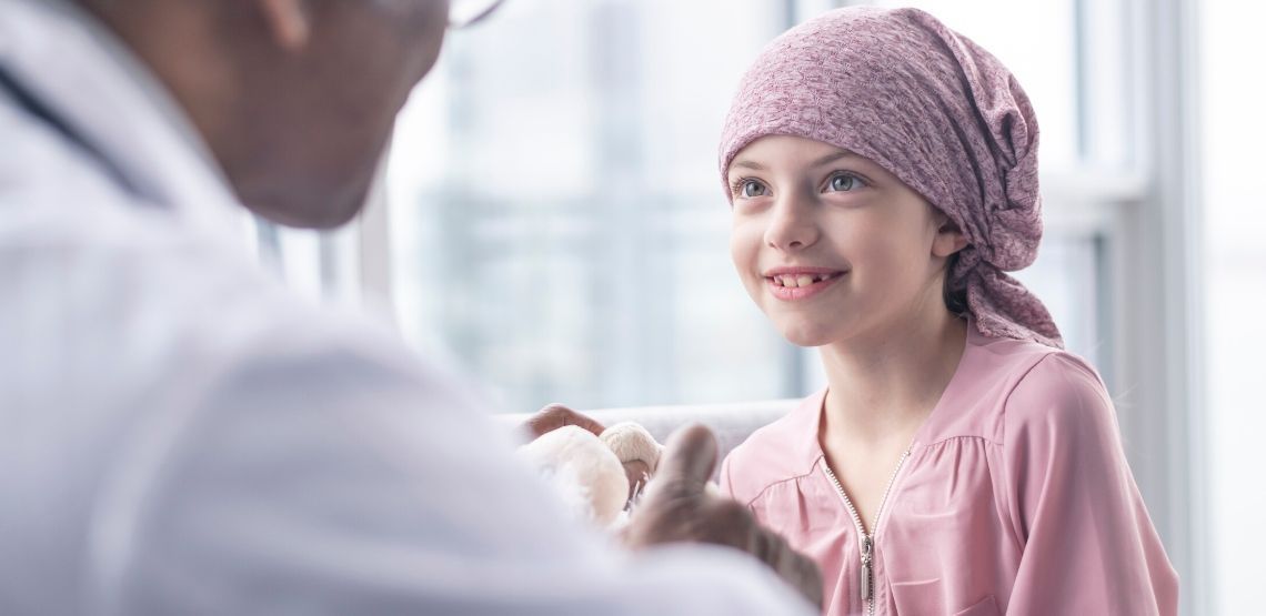 A doctor talking to a child with leukemia.