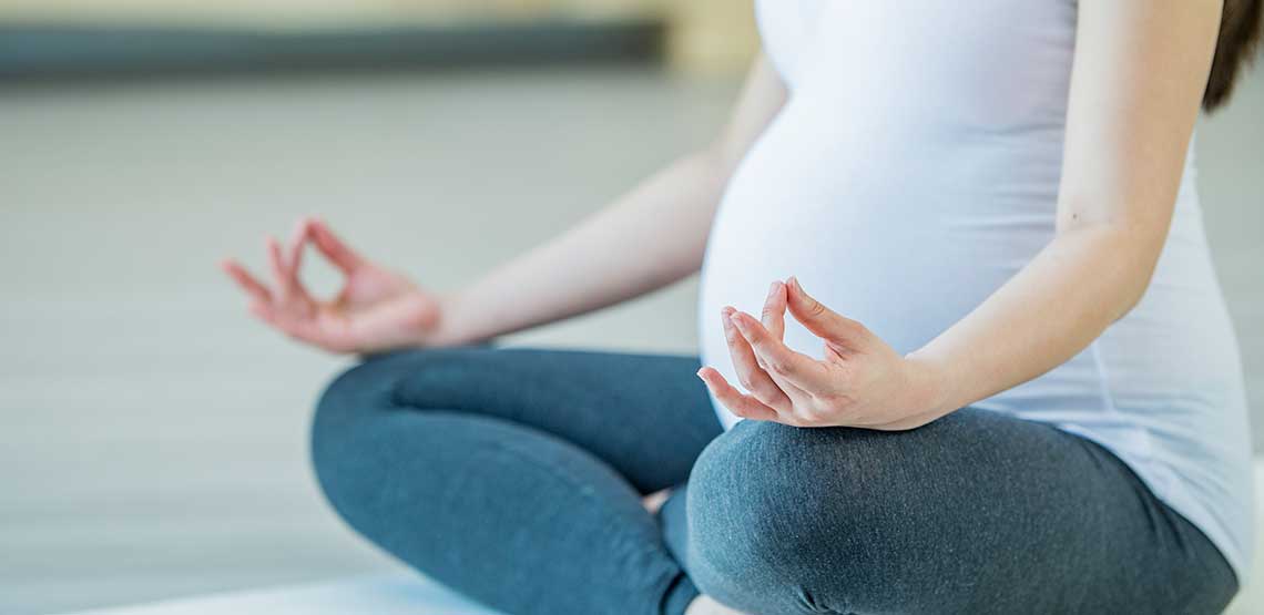 A pregnant woman doing a yoga pose