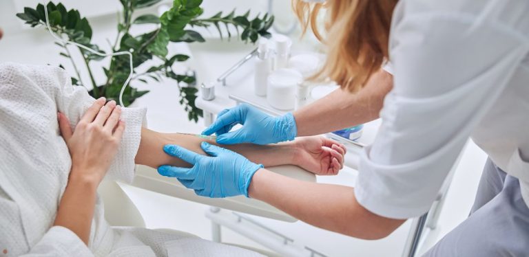 A patient receiving an IV injection from a health professional.